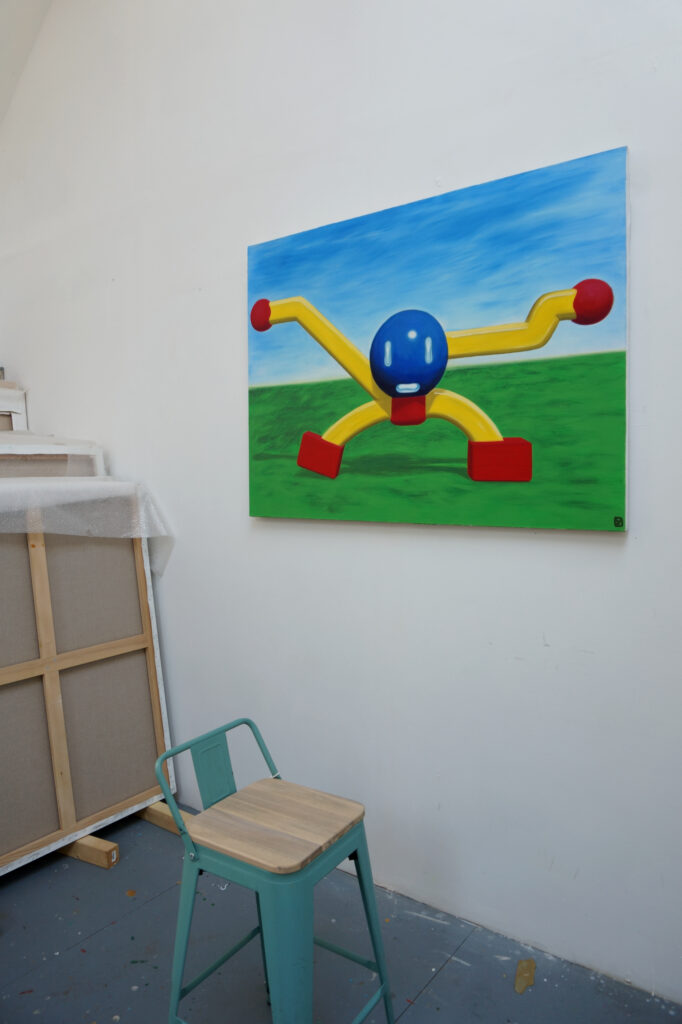 Peinture au mur de l'atelier de benoit andro un bonhomme géométrisé en 3D en couleurs primaires