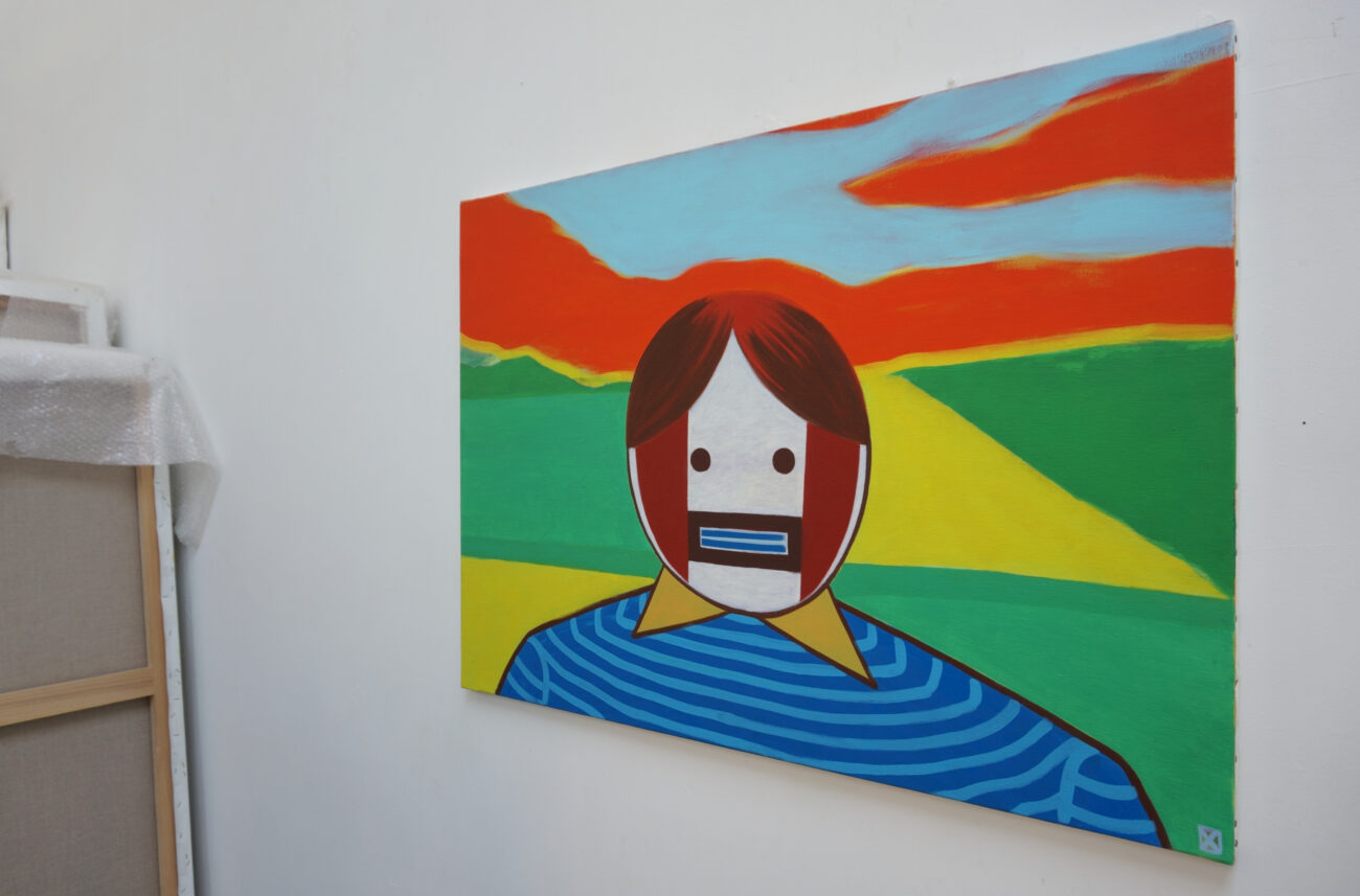 Peinture au mur de l'atelier de benoit andro où on peut voir un personnage géométrisé devant un vague paysage